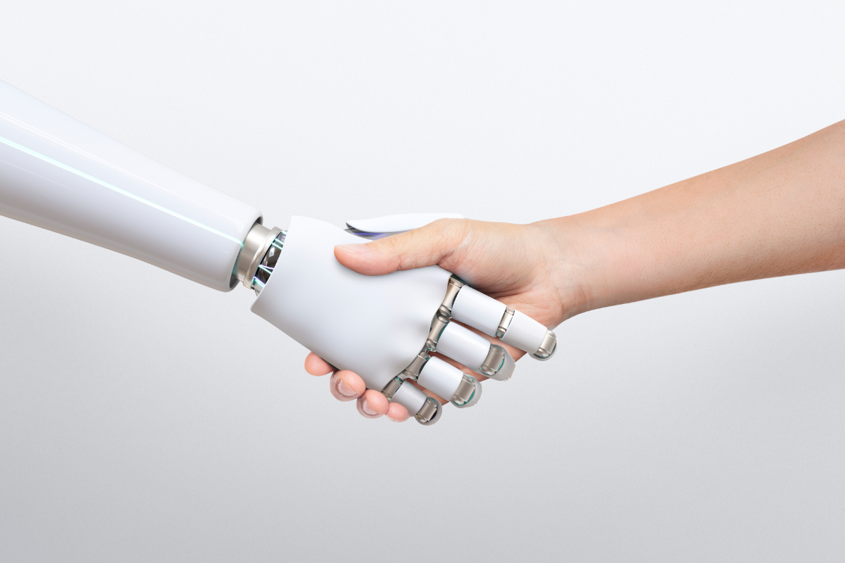 human and robot hands meeting, illustrative image for text about Amazon investing in AI.