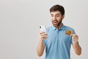 Man happy with the Benefits of Using a Credit Card.