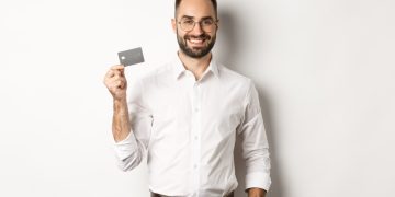 A guy hodling his Citi Premier Card.