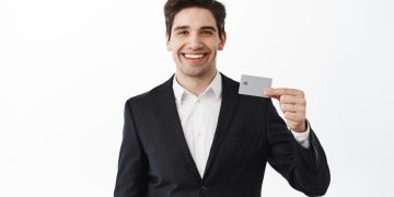 A guy holding his Aeroplan Credit Card.