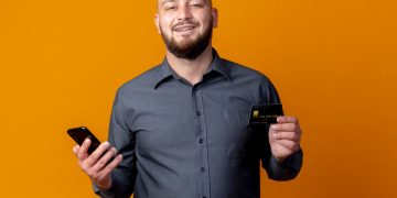 A guy holding his Bilt Mastercard.