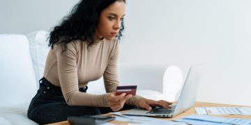 Woman studying to choose between checking vs savings accounts